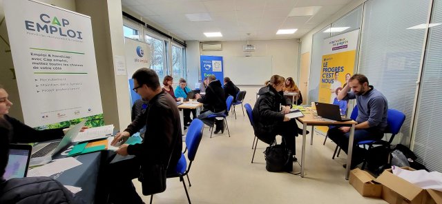 Des personnes sont présentes sur des stands pour prendre des renseignements