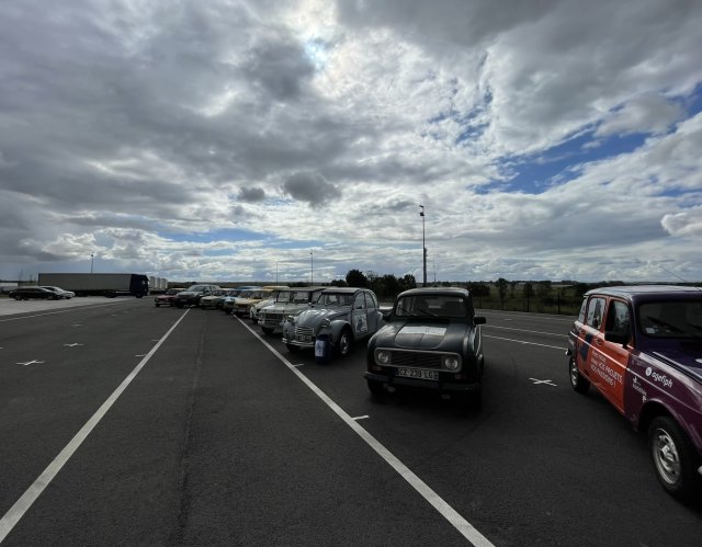 Les véhicules participant à la course sont stationnés en épis dans l'attente du départ sous une timide éclaircie