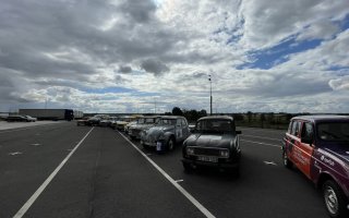 Les véhicules participant à la course sont stationnés en épis dans l'attente du départ sous une timide éclaircie